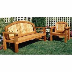 two wooden benches sitting in the grass next to each other