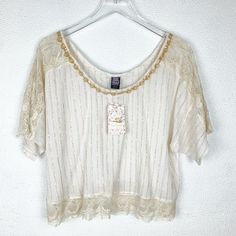 Short Sleeve Blouse In Ivory By Free People. Lace Detailing On Sleeves, Shoulders And Bottom Hem. Beaded Neckline. Oversized Fit. Metallic Golden Accents. Cottagecore Style. Pit To Pit: ~25" Length: 22" Condition: Nwt Any And All Flaws (If Existing) Are Noted In Listing. Bundle Up For A Discount! 500+ Items Available In My Closet. Q109 Chic Embellished Beige Tops, Chic Beige Embellished Tops, Elegant Cream Embellished Tops, Summer Embellished Lace Top, Summer Embellished Beige Blouse, Embellished White Blouse For Summer, Off White Bohemian Short Sleeve Top, Bohemian Off White Short Sleeve Tops, Embellished Cream Top For Summer