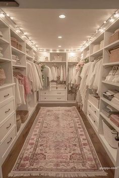 a walk in closet filled with lots of white furniture and hanging lights on the ceiling