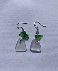 the earrings are made from glass and have green accents