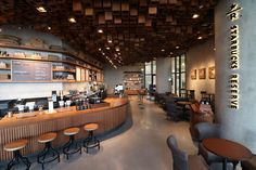 the inside of a restaurant with tables and stools