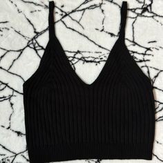 Size Medium Crop Black Sweater Tank From Fashion Nova. Never Worn Black Seamless V-neck Top, Black V-neck Crop Top For Spring, Black Seamless Crop Top For Fall, Black Seamless Tops For Summer, Black Seamless Summer Tops, Trendy Black Seamless Tops, Black Cami Top For Spring, Black Cami Top For Fall, Black Seamless Cami Top