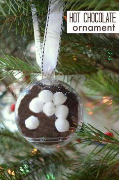 an ornament hanging from a christmas tree with marshmallows on it