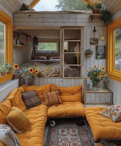 a living room with sunflowers on the windows and a couch in the corner