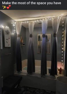 the bathroom is decorated with lights and curtains