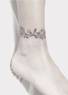 a woman's foot with a rose tattoo on the side of her left ankle