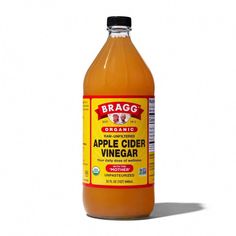 a bottle of apple cider vinegar on a white background