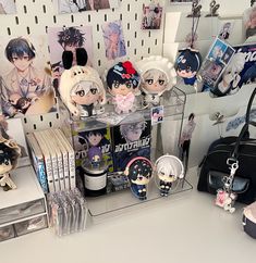 various anime figurines are on display in a store shelf next to a handbag