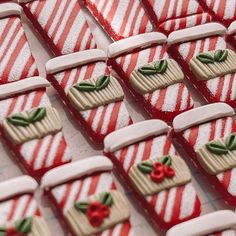 red and white striped cookies with green leaves on them are arranged in the shape of hearts