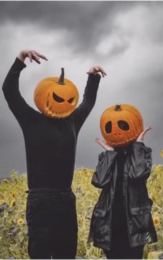 two people with pumpkins on their heads