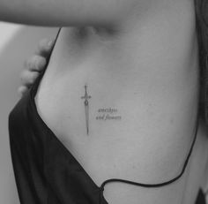 a woman with a cross tattoo on her chest and the words sometimes and forever written in cursive font