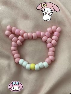 a pink and white beaded bracelet with an adorable bunny on it's side