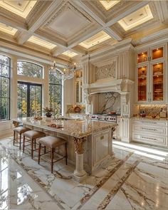 a large kitchen with marble counter tops and white cabinets