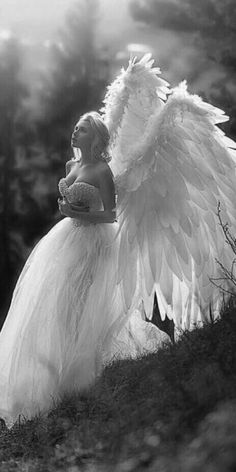 black and white photograph of a woman with angel wings