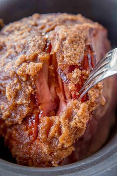 a close up of food in a pot with a fork sticking out of the top