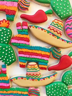 decorated cookies in the shape of mexican sombreros and hats on a white surface