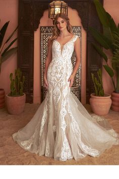 a woman in a wedding dress posing for the camera