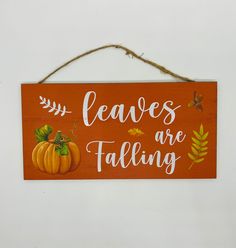 a wooden sign that says leaves are falling