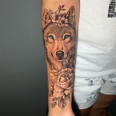 a woman's arm with a wolf and flowers on it