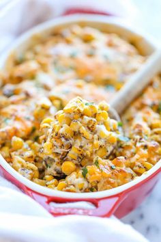 a spoon full of corn casserole with cheese