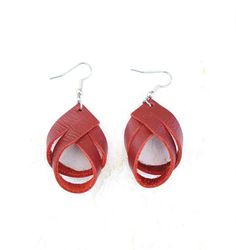 These charming deep red leather twist earrings are 1-1/2  inch long.  That is the length of the leather. Please see photos for the overall length.  They are the perfect size to enhance your outfit without being to bold. They are lightweight, you will forget that you are wearing them. I would suggest keeping them out of water. Leather tends to get spotted and can shrink.  They are suited for sensitive ears.  **USUALLY SHIPS NEXT DAY  *Nickle free hooks  PLEASE SEE PHOTOS FOR TOTAL LENGTH. GET COMPLIMENTS 😎 They look good with casual clothes, work clothes or a night out on the town with jeans and a shirt. They are subtle beauties. I'm sure you will get plenty of compliments! They also make great  gifts for someone special like your Bestie, Mom, daughter Aunt co-worker. You get the picture. Adjustable Handmade Red Teardrop Earrings, Everyday Leather Teardrop Earrings, Artisan Leather Teardrop Earrings, Adjustable Red Leather Earrings, Red Elegant Nickel-free Teardrop Earrings, Twist Earrings, Mom Daughter, Casual Clothes, Work Clothes