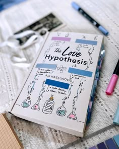 the love hypothhes book is laying on a table with pens and markers