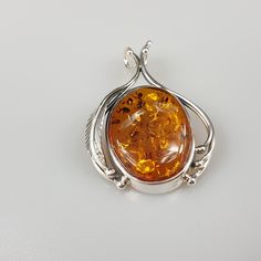 Elegant orange Amber pendant. Handmade of genuine Baltic Amber and sterling silver 925. With stamping. Weight: 8.01 gr Stone size 5 x 2.5 cm Please see more items and you find matching silver earrings. This item was made of natural Baltic Amber. All the amber used in my jewelry is collected in my home country Lithuania. I sell only genuine, real, not pressed, authentic, natural Baltic Amber. Item may have natural imperfections. Classic Orange Jewelry As Gift, Classic Orange Jewelry For Gift, Classic Orange Necklace For Gift, Classic Orange Necklace For Gifts, Orange Large Pendant Jewelry, Sterling Silver Orange Cabochon Jewelry, Orange Cabochon Sterling Silver Jewelry, Orange Sterling Silver Round Pendant Jewelry, Orange Polished Finish Jewelry For Gift