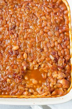 a casserole dish filled with baked beans and sauce