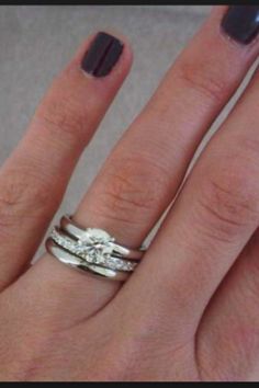 a woman's hand with two rings on it