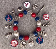 a bracelet with baseball charms on it and other sports related items around the clasps