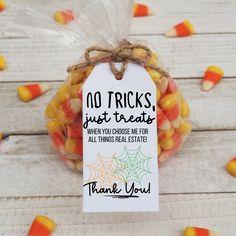 a bag filled with candy corn sitting on top of a wooden table