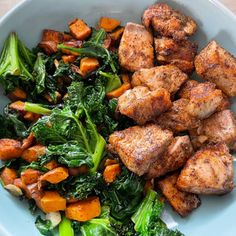 a bowl filled with meat and vegetables on top of a table