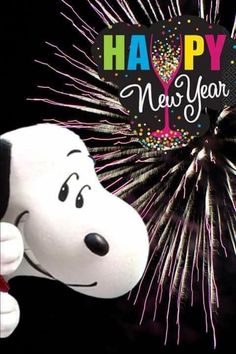 a happy new year card with a cartoon dog holding a wine glass and fireworks in the background