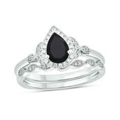 Win her heart with the vintage and nature-inspired details of this pear-shaped black sapphire and diamond frame bridal set in white gold. Fashioned in cool 10K white gold The engagement ring showcases a 7.0 x 5.0mm pear-shaped rich black sapphire glistening in a diamond-lined frame. Leaf-like marquise shapes flank the centerpiece with diamonds. Seal your vows with the coordinating wedding band, shimmering with a row of diamond duos in marquise-shaped frames. Intricate milgrain borders add heirlo Framed Leaves, Gold Book, Diamond Frame, Black Sapphire, Diamond Bridal Sets, Gemstone Engagement Rings, Bridal Set, Bridal Sets