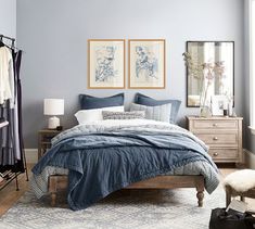 a bedroom with blue walls and wooden floors