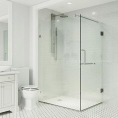 a white bathroom with a glass shower door