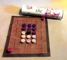 a game board with pieces on it next to a tube of toothpaste