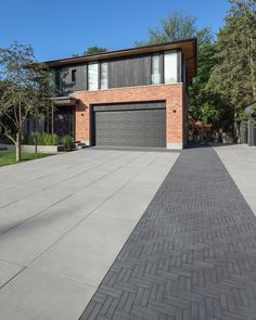 a large brick house with two garage doors