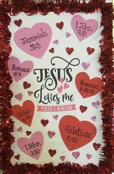 a sign that says jesus loves me, and hearts on the front with red tinsel