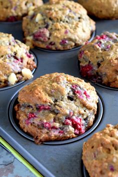 muffins with cranberries and other toppings in a baking pan