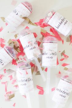 pink and gold confetti sticks with writing on them