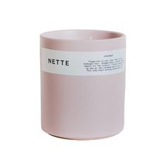 a pink mug with a white label on the side that says nette in black lettering