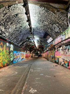 the inside of an abandoned subway station with graffiti all over it