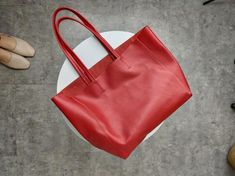 Overview: Design: Fashion Womens Red Leather Oversize Tote Bag Red Shoulder Tote Bag Handbag Tote For WomenIn Stock: Made to order (2-3 days)Include: Tote + A detachable Side InnerCustom: NoColor: RedLeather: CowhideMeasures: Horizontal Style S: 46cm/Bottom 34cm x 30cm x 14cmHorizontal Style L: 50cm/Bottom 37cm x 33cm x 16cm Vertical Style S: 41cm/Bottom 33cm x 35cm x 11cm Vertical Style L: 47cm/Bottom 37cm x 40cm x 11cmWeight: 0.75 kgSlots: 1 slotAccessories(option): NoStyle: Tote Bag, Shoulder Red Rectangular Bucket Bag With Large Capacity, Red Large Capacity Rectangular Bucket Bag, Red Rectangular Large Capacity Bucket Bag, Elegant Large Size Bags For Errands, Elegant Large Size Satchel For Shopping, Red Bucket Bag With Large Capacity And Top Handle, Large Leather Bag For Daily Use, Large Rectangular Leather Shoulder Bag, Red Square Shoulder Bag For Daily Use