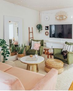 a living room filled with furniture and a flat screen tv mounted to the side of a wall