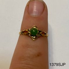 Smaller gold colored ring with small round jade colored stone. Vintage ring inventory form my great grandmother's restaurant and gift shop in Silverton, CO that she owned and operated from the 1960s to 1996. Style 1379SJP Sizes available: Size 4 - qty 2 Size 4.5 - qty 4 Size 5 - qty 5 Gold Jade Ring, Vintage Gold Jewelry With Round Stone, Vintage Gold Opal Promise Ring, Gold Vintage Opal Promise Ring, Antique Gold Round Emerald Ring, Vintage Gold Emerald Birthstone Ring, Vintage Green Opal Ring For Anniversary, Vintage Round Jade Rings, Vintage Green Opal Round Ring