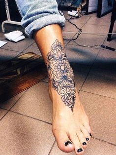 a woman's foot with a tattoo on it