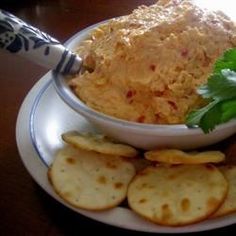 a white plate topped with crackers and dip