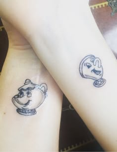 two people with tattoos on their arms, one has a teapot and the other has a dog