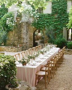 a long table is set up outside in the garden